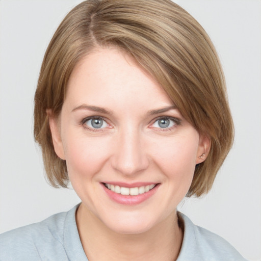 Joyful white young-adult female with medium  brown hair and blue eyes