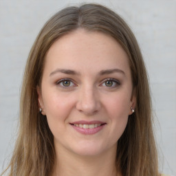 Joyful white young-adult female with long  brown hair and grey eyes