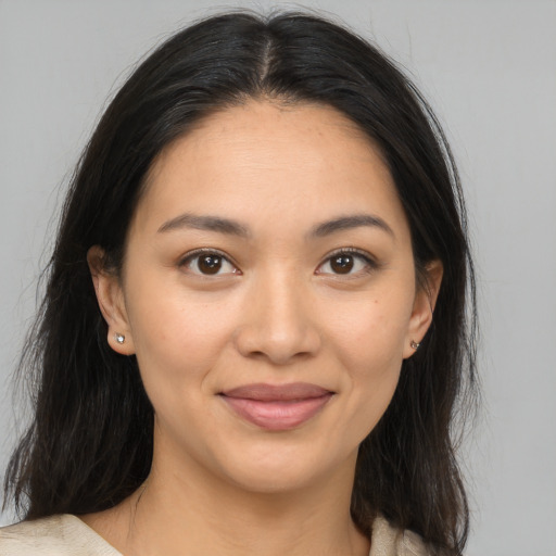 Joyful latino young-adult female with medium  brown hair and brown eyes