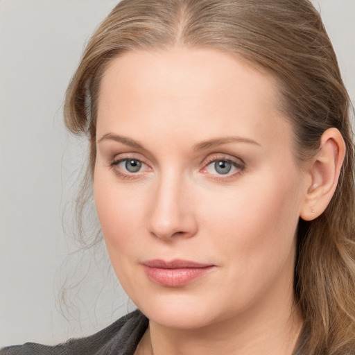 Joyful white young-adult female with long  brown hair and blue eyes