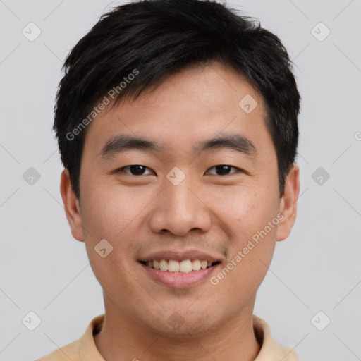 Joyful asian young-adult male with short  brown hair and brown eyes