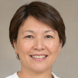 Joyful white adult female with medium  brown hair and brown eyes