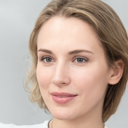 Joyful white young-adult female with medium  brown hair and blue eyes