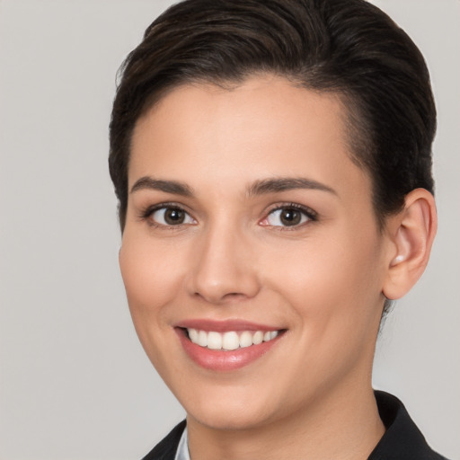 Joyful white young-adult female with short  brown hair and brown eyes