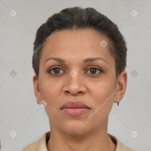 Joyful latino adult female with short  brown hair and brown eyes