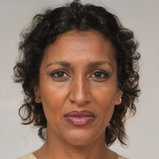 Joyful black adult female with medium  brown hair and brown eyes