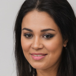 Joyful latino young-adult female with long  brown hair and brown eyes