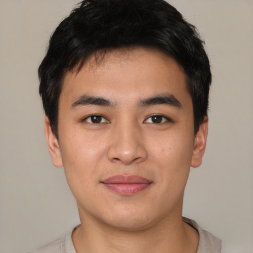 Joyful asian young-adult male with short  black hair and brown eyes