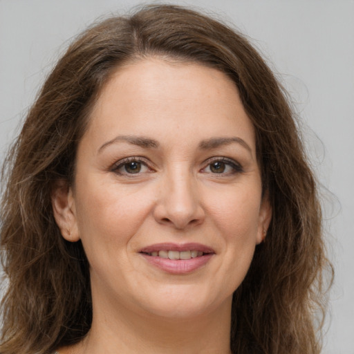 Joyful white young-adult female with long  brown hair and grey eyes