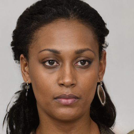 Neutral black young-adult female with long  brown hair and brown eyes