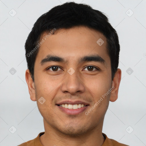 Joyful latino young-adult male with short  brown hair and brown eyes