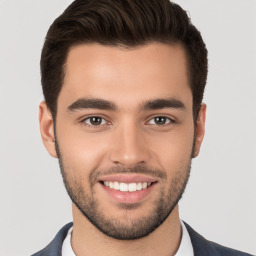 Joyful white young-adult male with short  brown hair and brown eyes