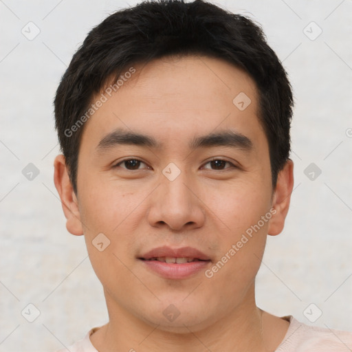 Joyful asian young-adult male with short  brown hair and brown eyes