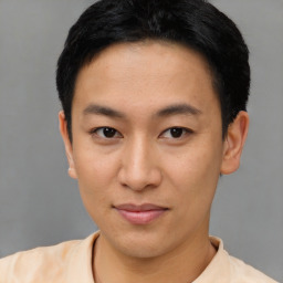 Joyful asian young-adult male with short  black hair and brown eyes