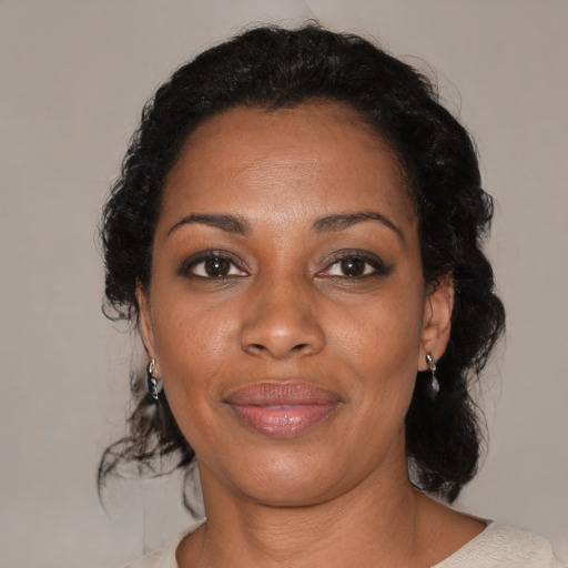 Joyful black young-adult female with medium  black hair and brown eyes