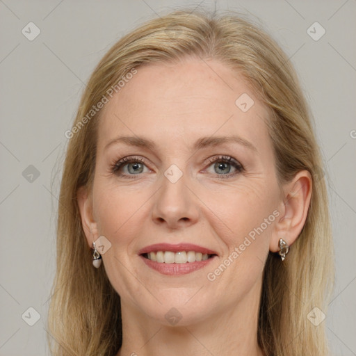 Joyful white adult female with long  brown hair and grey eyes