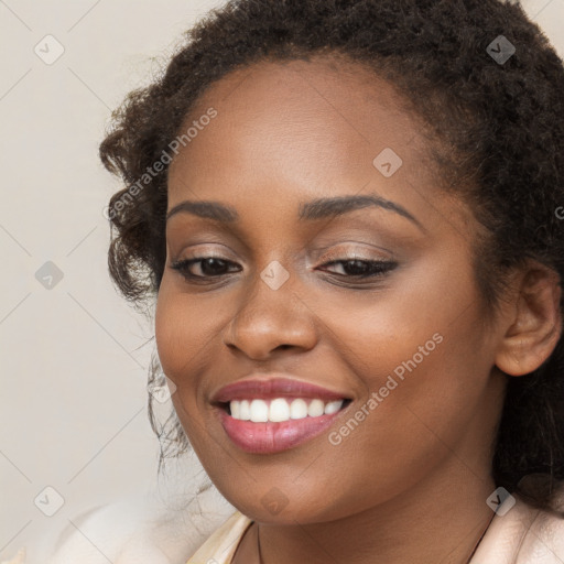 Joyful black young-adult female with long  brown hair and brown eyes