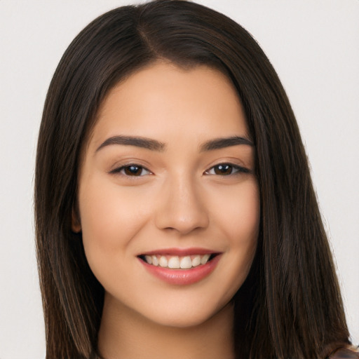 Joyful white young-adult female with long  brown hair and brown eyes