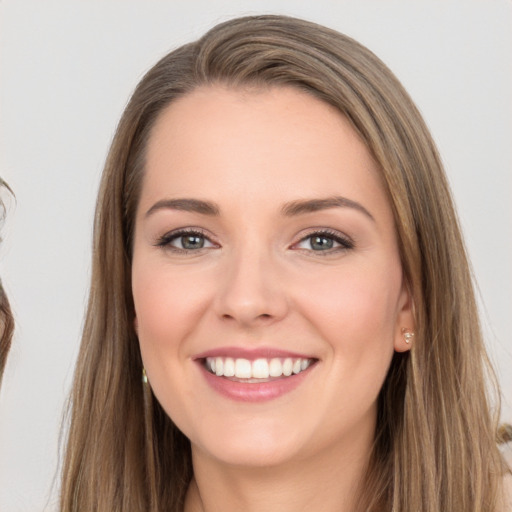 Joyful white young-adult female with long  brown hair and brown eyes