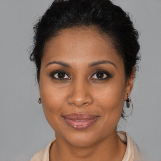 Joyful black young-adult female with medium  brown hair and brown eyes