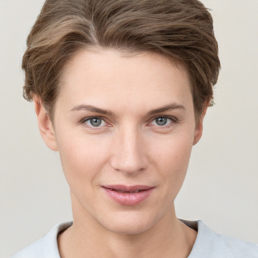 Joyful white young-adult female with short  brown hair and grey eyes