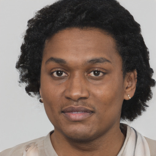 Joyful black young-adult male with short  black hair and brown eyes
