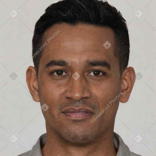 Joyful latino young-adult male with short  black hair and brown eyes