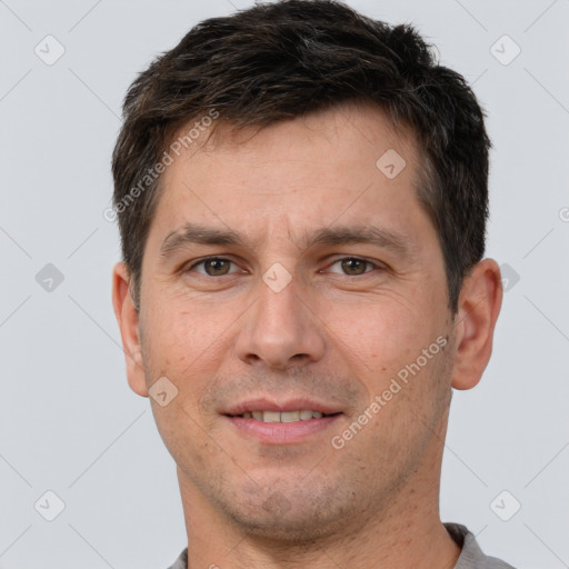 Joyful white adult male with short  brown hair and brown eyes