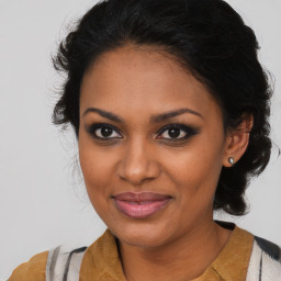 Joyful black young-adult female with medium  brown hair and brown eyes