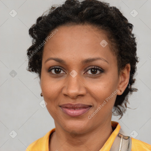 Joyful black young-adult female with short  brown hair and brown eyes