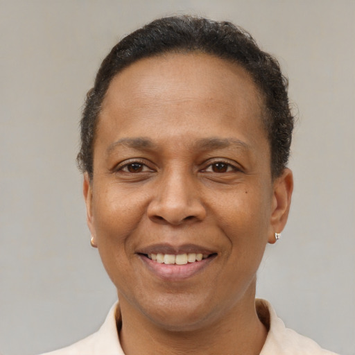 Joyful latino adult female with short  brown hair and brown eyes