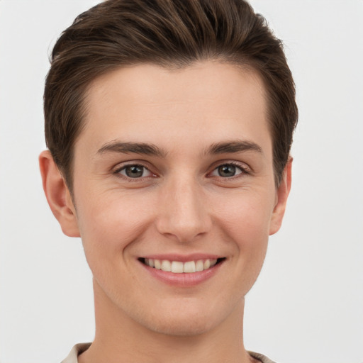 Joyful white young-adult female with short  brown hair and grey eyes