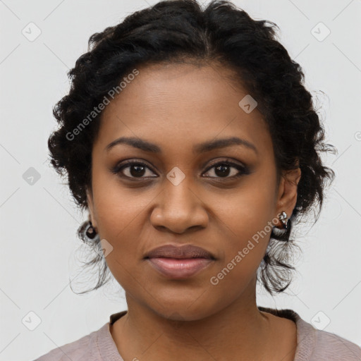 Joyful black young-adult female with long  black hair and brown eyes