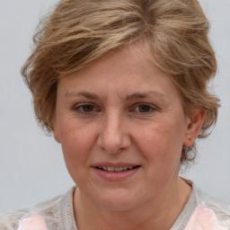 Joyful white adult female with medium  brown hair and blue eyes