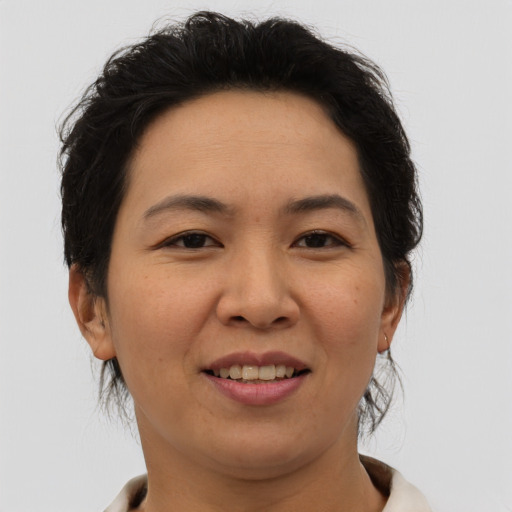 Joyful asian young-adult female with short  brown hair and brown eyes