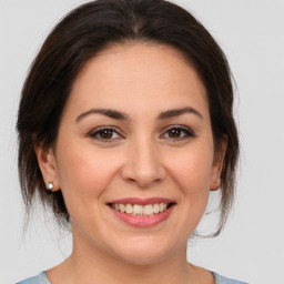 Joyful white young-adult female with medium  brown hair and brown eyes