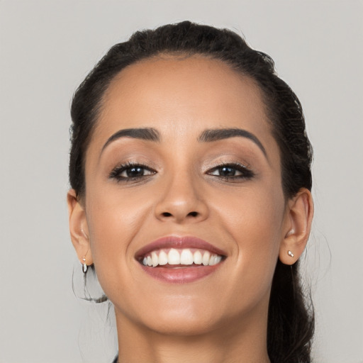 Joyful white young-adult female with long  black hair and brown eyes