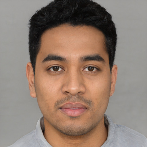 Neutral latino young-adult male with short  black hair and brown eyes