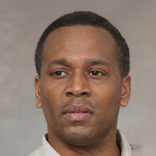 Neutral latino adult male with short  black hair and brown eyes