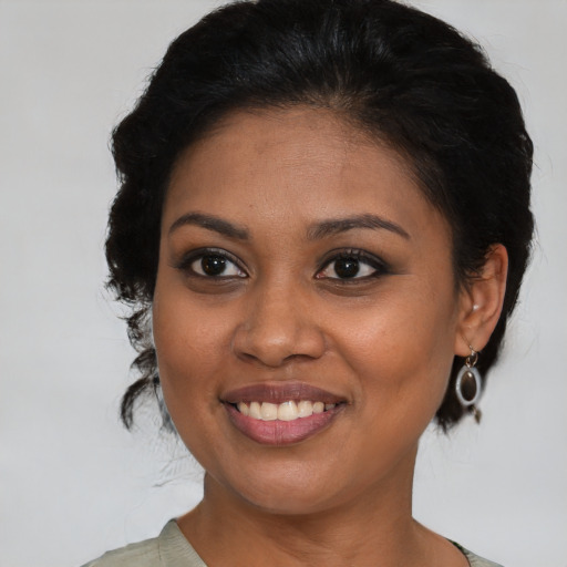 Joyful black young-adult female with medium  brown hair and brown eyes