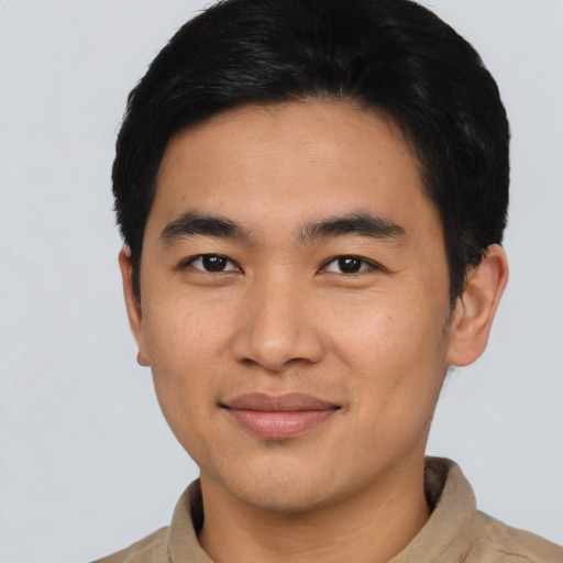 Joyful asian young-adult male with short  black hair and brown eyes