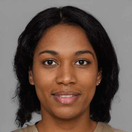 Joyful black young-adult female with medium  black hair and brown eyes