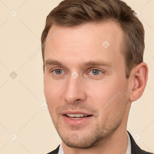 Joyful white young-adult male with short  brown hair and brown eyes