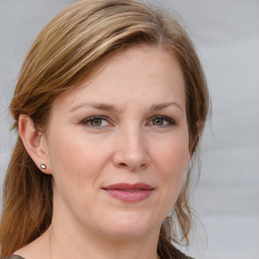 Joyful white young-adult female with medium  brown hair and blue eyes