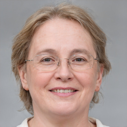 Joyful white middle-aged female with medium  brown hair and blue eyes