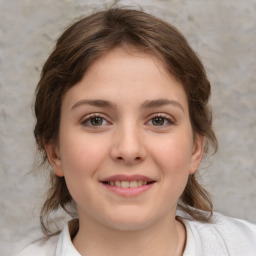 Joyful white child female with medium  brown hair and grey eyes