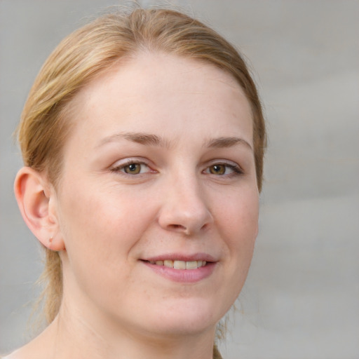 Joyful white young-adult female with medium  brown hair and blue eyes