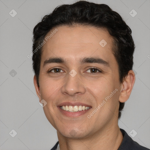 Joyful white young-adult male with short  black hair and brown eyes