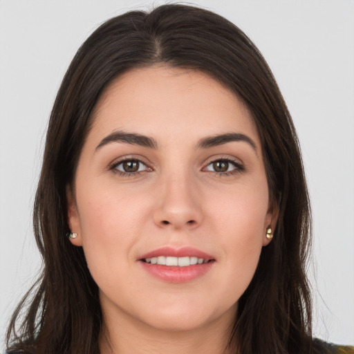 Joyful white young-adult female with long  brown hair and brown eyes