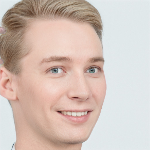 Joyful white young-adult male with short  brown hair and blue eyes